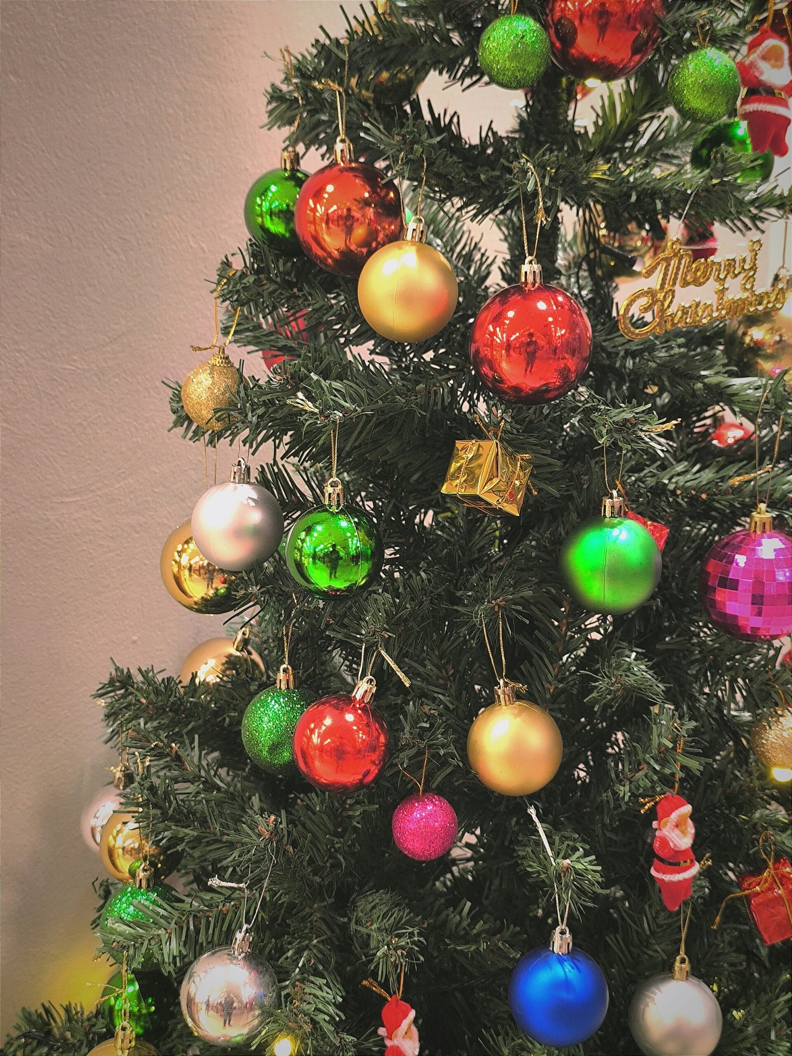 A small christmas tree with ornaments on it